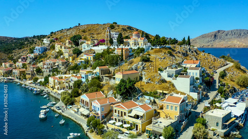 Simi island Greece view from the drone on the colorful houses and Bay of the sea with ships © vladimircaribb