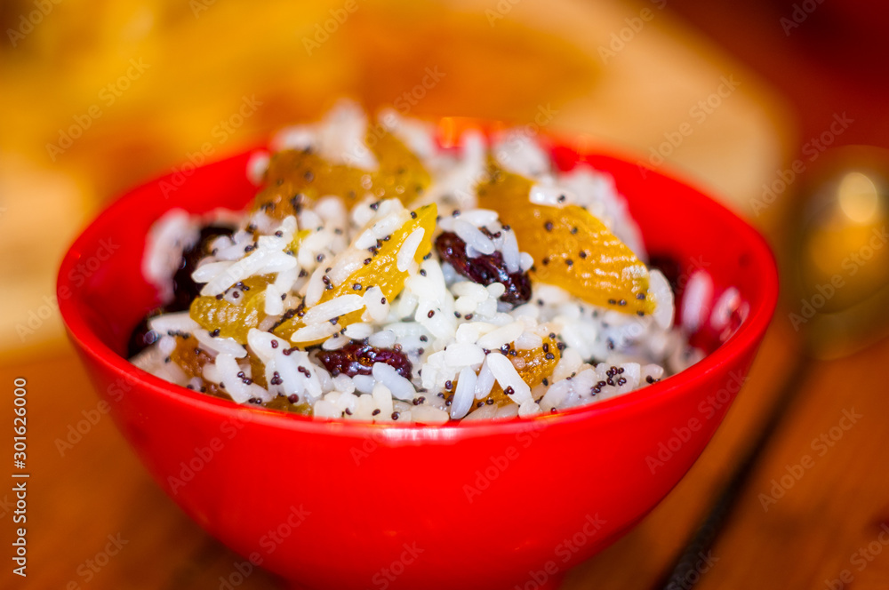 handmade preparation of treats for traditional Orthodox Christmas - rice pudding with fruits, cranberries, honey, nuts, Church candles handmade preparation of treats for traditional Orthodox Christmas - rice pudding with fruits, cranberries, honey, nuts, Church candles