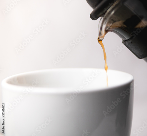 A french press pouring coffee