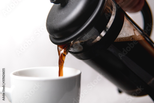A coffee cup being filled with coffee