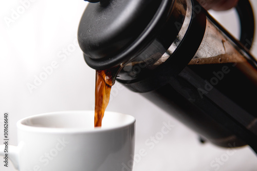 A french press pouring coffee