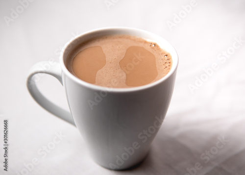 A cup off coffee sitting against a white background