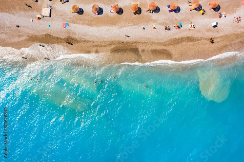 beach umbrellas sand vacationers transparent turquoise sea, beautiful bottom, top view from drone, the concept of a holiday resort