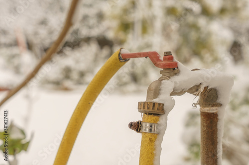 frozen faucet to water the garden plants