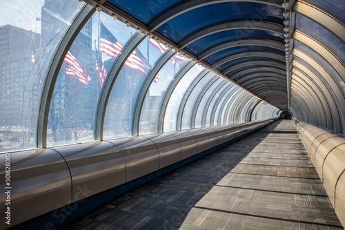 Pedestrian tunnel in downtown Detroit showing American flags outside