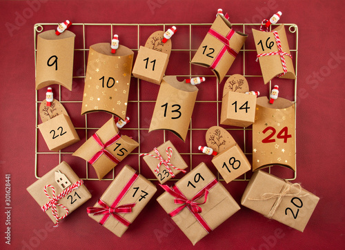 Advent calendar with craft carton boxes on the mesh board photo