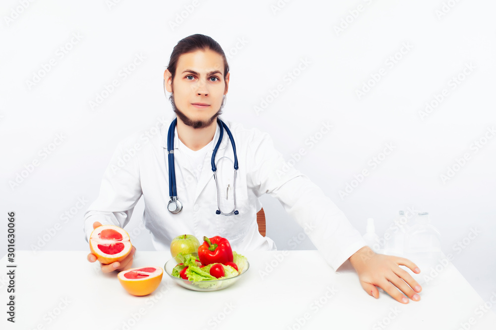 young pretty doctor with stethoscope holding fruits, vegetables and pills, syringe, healthy food care concept young pretty doctor with stethoscope holding fruits, vegetables and pills, syringe, healthy food care concept