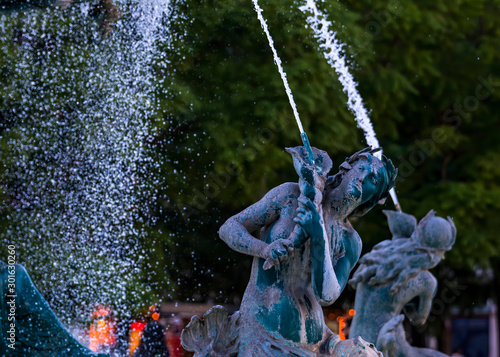 Beautiful image with baroque style bronze fountain with the four Mermaid Statues on Rossio square in Lisbon, Portugal.