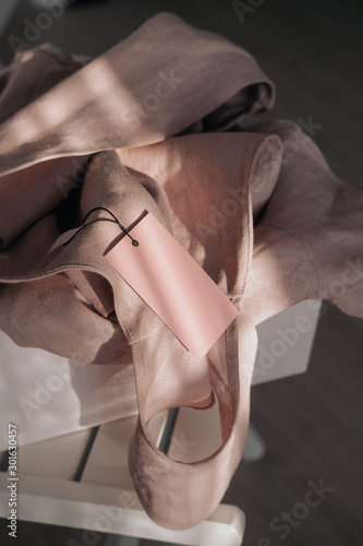 Pink linen dress with tag in white box © Iuliia