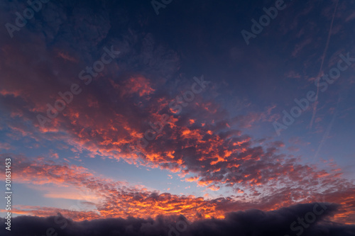A dramatic sunset or sunrise sky with clouds. Orange and purple colors on a dramatic looking sky. © Ondra