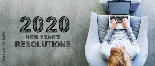 2020 New Years Resolutions with man using a laptop in a modern gray chair