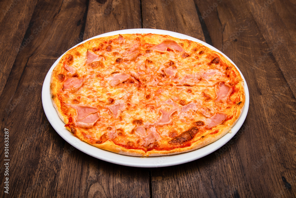classic Italian pizza on a wooden table classic Italian pizza on a wooden table