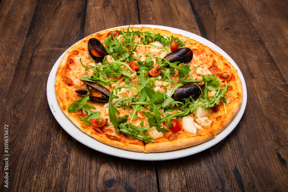 classic Italian pizza on a wooden table classic Italian pizza on a wooden table