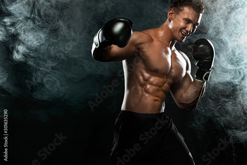 Boxer, man fighting or posing in gloves on black background. Fitness and boxing concept. Individual sports recreation. © Mike Orlov