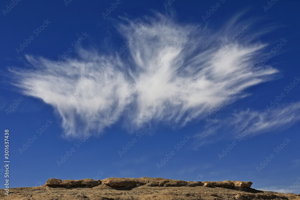 Cirrus uncinus-mares.tails clouds over yardang-wind eroded rock surface. Qaidam desert-Qinghai-China-0571