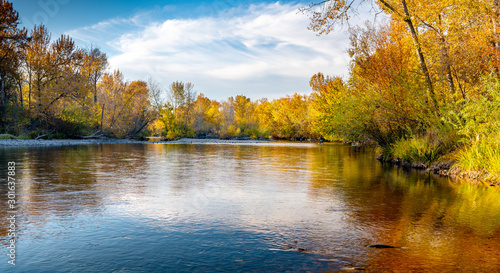 Boise river adorned in fall colored trees with reflection in the water
