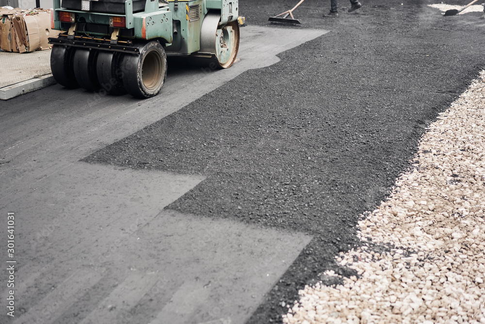 Asphalt Compactors is carrying out road repair work. Laying new asphalt. Large heavy machinery. Construction of a new asphalt road. Asphalt Compactors is carrying out road repair work. Laying new asphalt. Large heavy machinery. Construction of a new asphalt road.