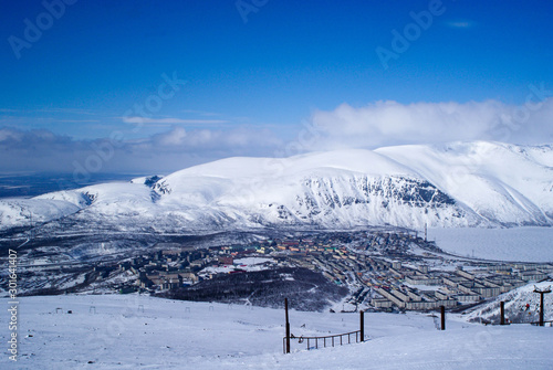 Kirovsk, Murmansk region winter - mountain range and town and lake