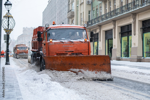 the city snow cleaning service department at work in the public streets, cold season