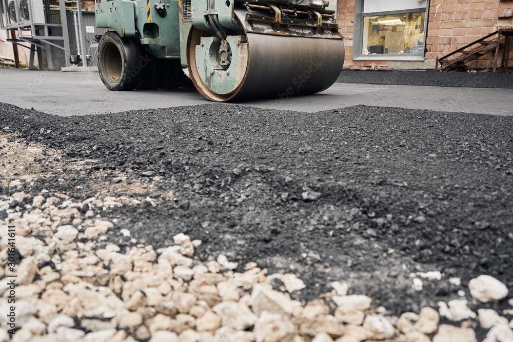 Asphalt Compactors is carrying out road repair work. Laying new asphalt. Large heavy machinery. Construction of a new asphalt road. Asphalt Compactors is carrying out road repair work. Laying new asphalt. Large heavy machinery. Construction of a new asphalt road.