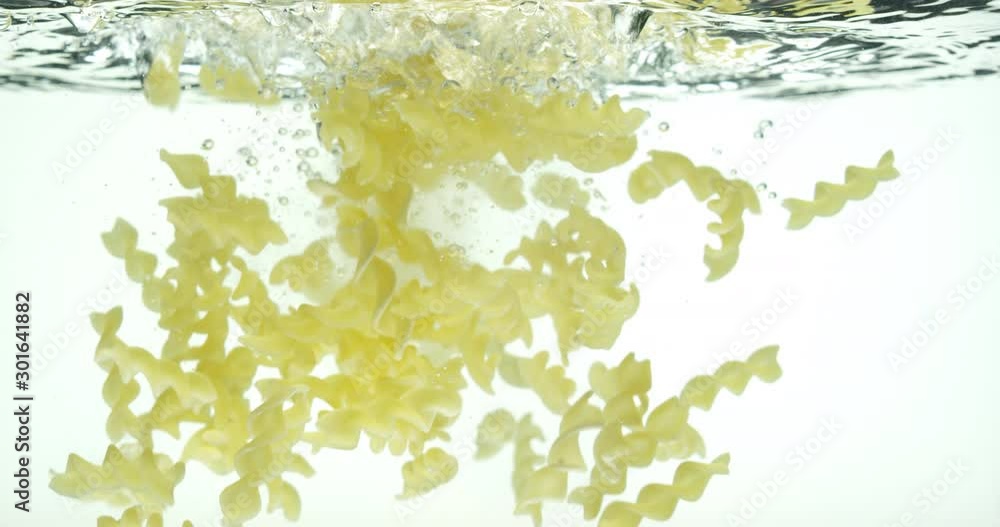 Pasta falls into water isolated, slow motion, shot on Red Weapon Helium, bubbles in water, splashes, Laowa Probe Macro 24mm lens Pasta falls into water isolated, slow motion, shot on Red Weapon Helium, bubbles in water, splashes, Laowa Probe Macro 24mm lens