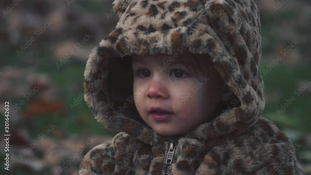 Toddler girl exploring a park on a cold fall day. Cinematic 4K footage. Toddler girl exploring a park on a cold fall day. Cinematic 4K footage.