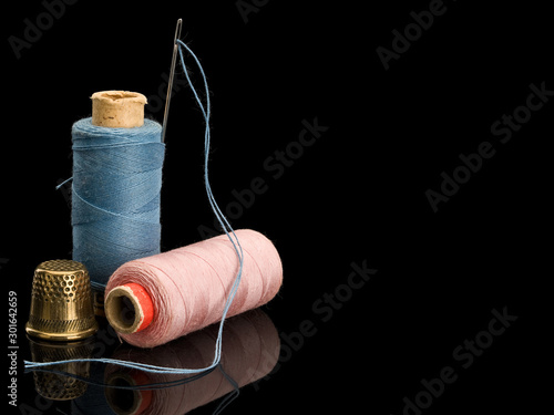 Sewing threads of blue and pink colors