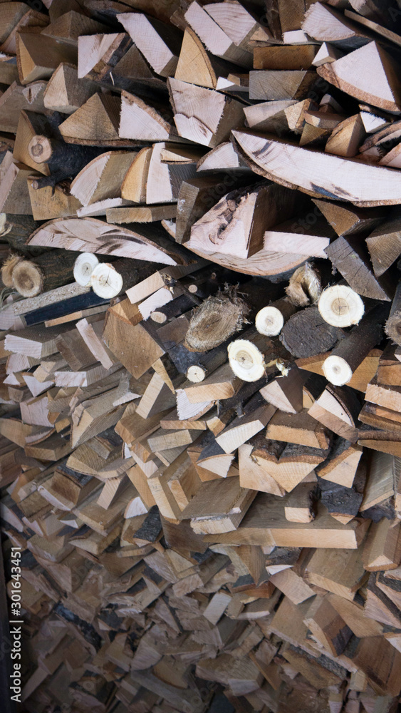 Wooden logs, beams, firewood, frame.Detail of logs stacked for firewood. Background of dry chopped firewood logs in a pile. Harvesting firewood for the winter. Wooden logs, beams, firewood, frame.Detail of logs stacked for firewood. Background of dry chopped firewood logs in a pile. Harvesting firewood for the winter.