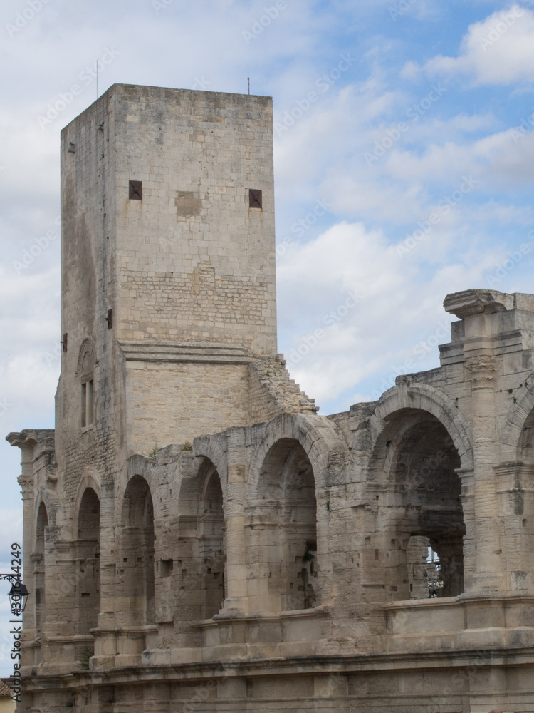 Stone tower in an amphitheater with arches in Arles, France