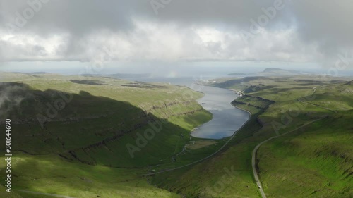 Aerial drone video flying over Kaldbaksfjordur fiord and Kaldbaksbotnur village near popular tourist point - Sornfelli, Streymoy island, Faroe Islands, Denmark. UHD 4k video photo