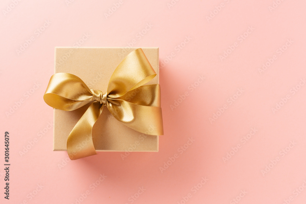 Gift box with golden ribbon on pink background - obrazy, fototapety, plakaty 