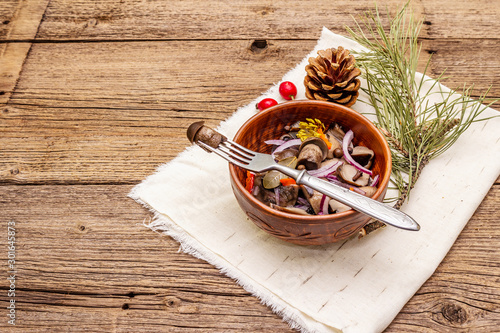 Pickled (fermented) mushrooms. Traditional New Year (Christmas) snack. Festive table cutlery setting