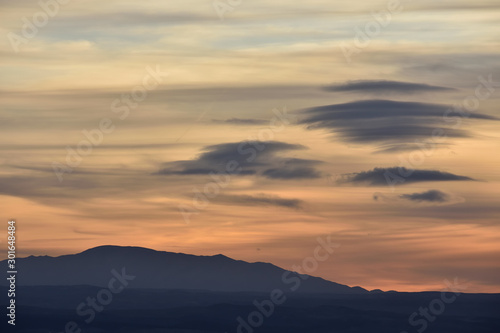 splendid autumn sunset with different types and colors of lenticular clouds © Miguel Ángel RM