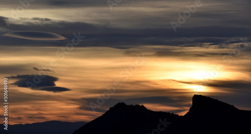 splendid autumn sunset with different types and colors of lenticular clouds