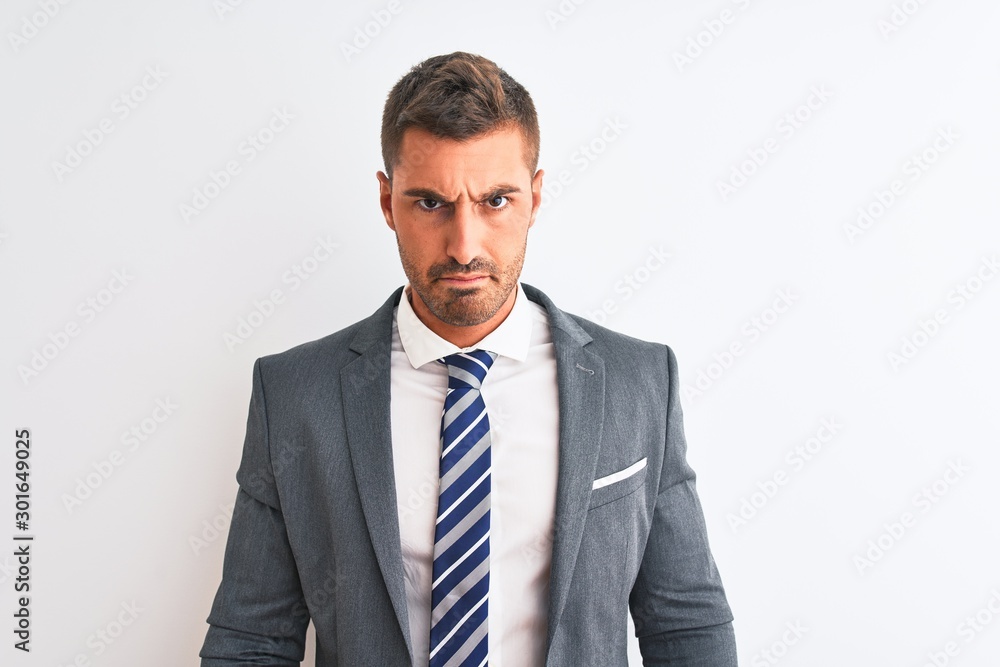 Young handsome business man wearing suit and tie over isolated background Relaxed with serious expression on face. Simple and natural looking at the camera. Young handsome business man wearing suit and tie over isolated background Relaxed with serious expression on face. Simple and natural looking at the camera.