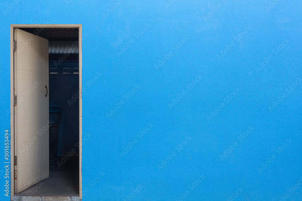 old white door on blue cement wall old white door on blue cement wall