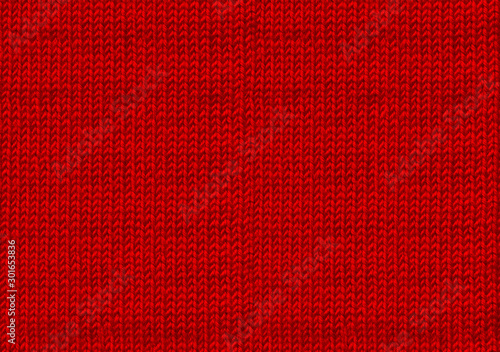 Ugly sweater Christmas party. Red knitted background. The warm sweater from yarn. New year backdrop. Texture of the wool or acrylic knit