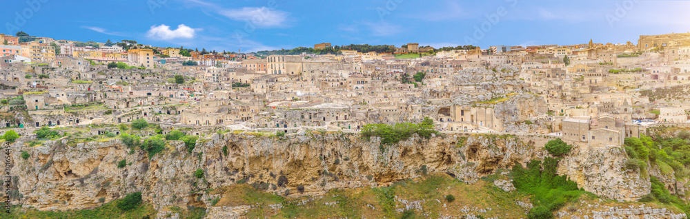 Aerial panoramic view of historical centre Sasso Caveoso old ancient town Sassi di Matera with cave rock houses with dramatic sky, view from Murgia Timone, UNESCO Heritage, Basilicata, Southern Italy