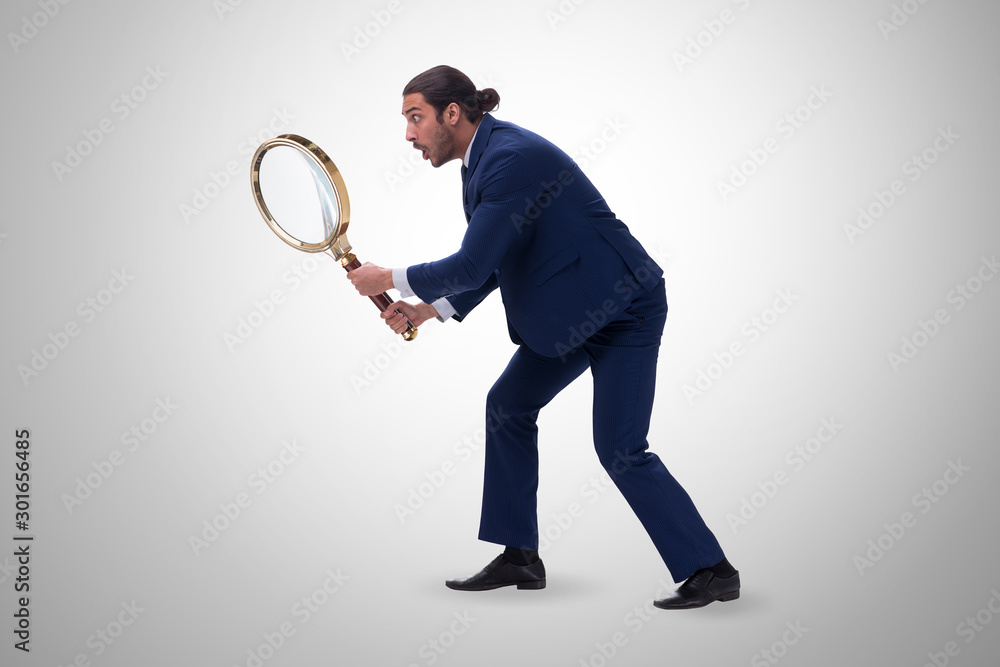 Businessman with giant magnifying glass