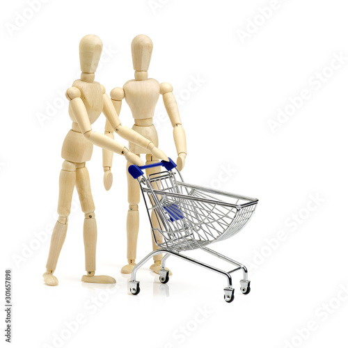 Shopping concept. Wooden doll and metal shopping cart. © zcy