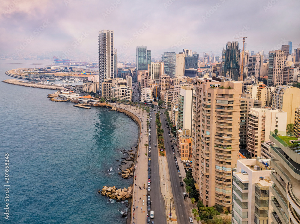 Fototapeta premium Beirut's corniche sea front with high rise residential buildings and pedestrian walkway along the Mediterranean sea, Lebanon