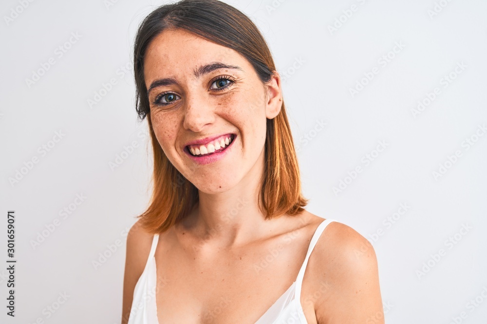 Beautiful redhead woman wearing casual white t-shirt over isolated background with a happy face standing and smiling with a confident smile showing teeth Beautiful redhead woman wearing casual white t-shirt over isolated background with a happy face standing and smiling with a confident smile showing teeth