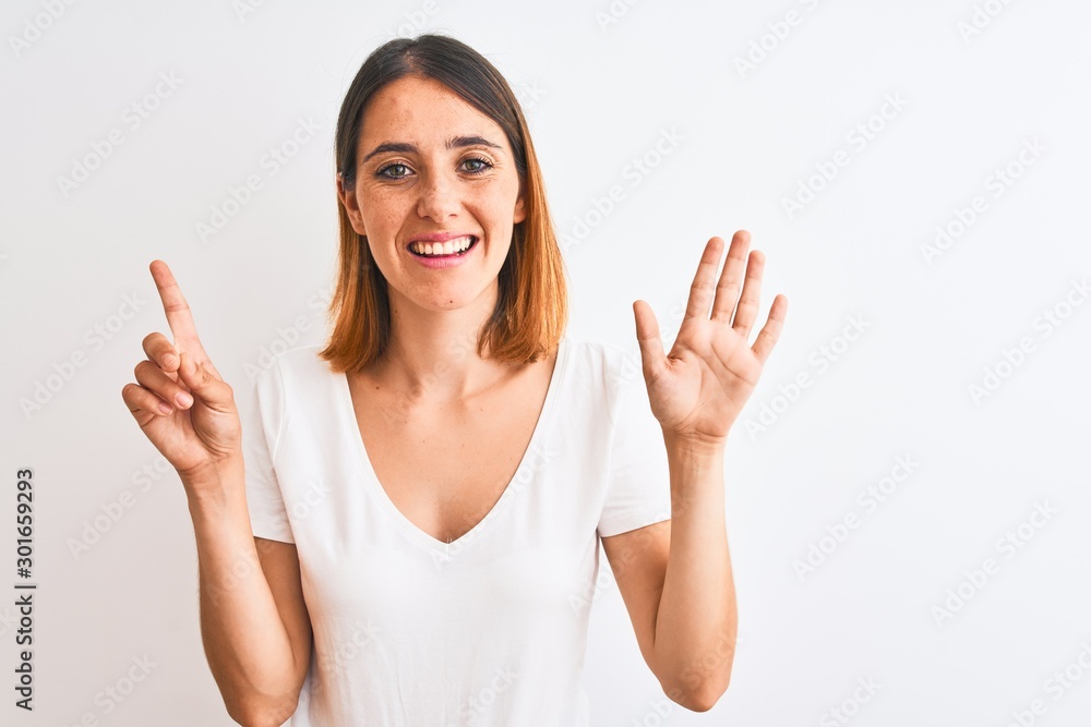 Beautiful redhead woman wearing casual white t-shirt over isolated background showing and pointing up with fingers number six while smiling confident and happy. Beautiful redhead woman wearing casual white t-shirt over isolated background showing and pointing up with fingers number six while smiling confident and happy.