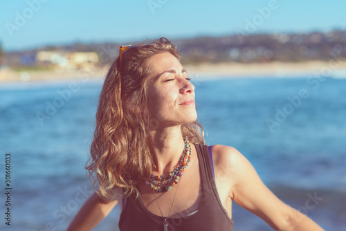 woman standing in the sun near the beach © gillianvann