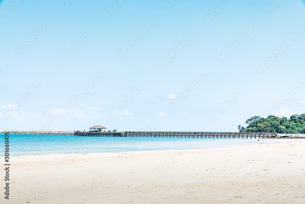 Jetty with sea view and blue sky in summer at coast of Thailand