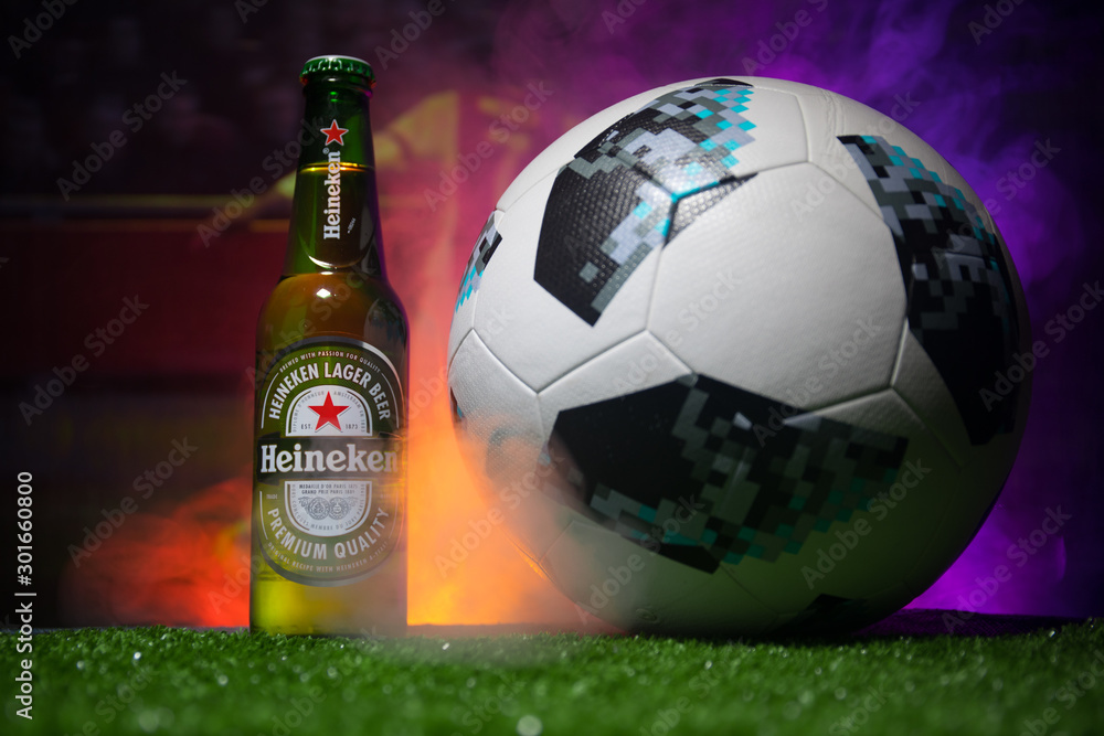 BAKU,AZERBAIJAN - JUNE 21, 2018 : Heineken Lager Beer in bottle with  Official Russia 2018 World Cup football ball The Adidas Telstar 18 on dark  toned foggy background. Stock Photo | Adobe Stock