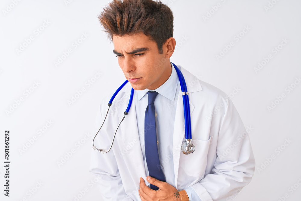 Young handsome doctor man wearing stethoscope over isolated white background with hand on stomach because indigestion, painful illness feeling unwell. Ache concept. Young handsome doctor man wearing stethoscope over isolated white background with hand on stomach because indigestion, painful illness feeling unwell. Ache concept.