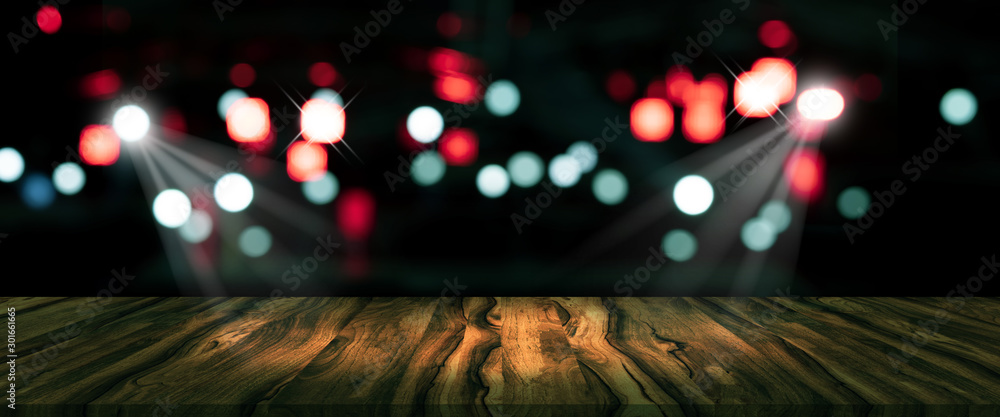 top desk with blur restaurant background,long wooden table and blurred bokeh of night street background