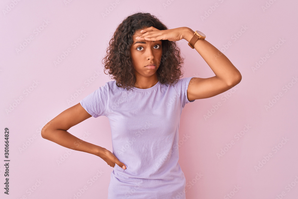 Young brazilian woman wearing t-shirt standing over isolated pink background worried and stressed about a problem with hand on forehead, nervous and anxious for crisis Young brazilian woman wearing t-shirt standing over isolated pink background worried and stressed about a problem with hand on forehead, nervous and anxious for crisis