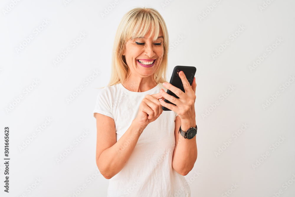 Middle age woman using smartphone standing over isolated white background with a happy face standing and smiling with a confident smile showing teeth Middle age woman using smartphone standing over isolated white background with a happy face standing and smiling with a confident smile showing teeth